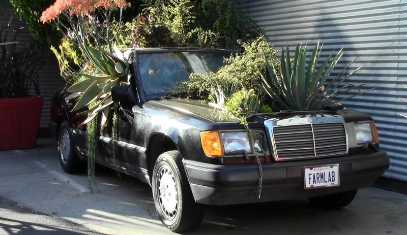 An up-cycled car turned planter displayed outdoors in the Bergamot Station Arts District of Santa Monica.