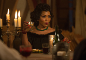 Desiree (Angela Bassett) smiles knowingly during a very special feast (FX).