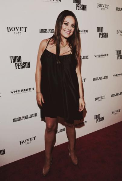 A stunning Mila Kunis smiling at a movie premiere (YeahMilaKunis/Tumblr)