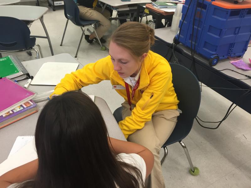 A City Year member helps a student with her homework during an after-school session (Diana Lee/Neon Tommy).