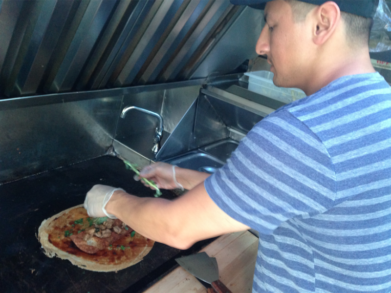 Mike Nassif prepares a traditional Chinese egg pancake, jian bing, in his food truck Buddha Bing. (Ciara Lunger/Neon Tommy) Mike Nassif prepares a traditional Chinese egg pancake, jian bing, in his food truck Buddha Bing. (Ciara Lunger/Neon Tommy)
