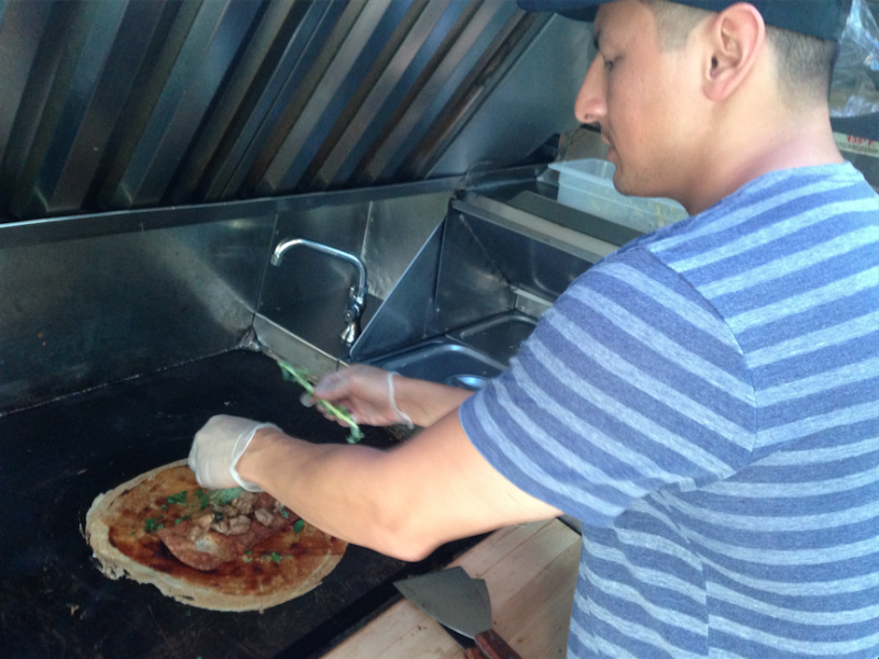 Mike Nassif prepares a traditional Chinese egg pancake, jian bing, in his food truck Buddha Bing. (Ciara Lunger/Neon Tommy)