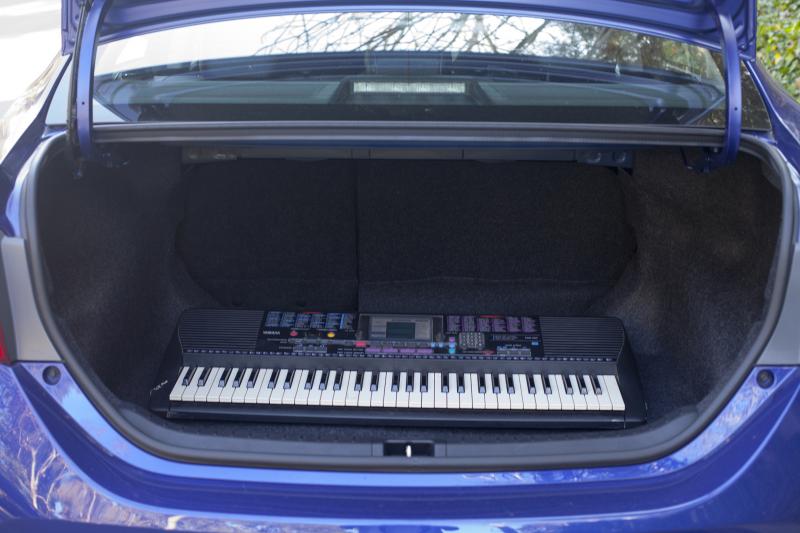 The size of the Corolla's trunk is demonstrated using a Yamaha PSR-220 (Amou "Joe" Seto/Neon Tommy)