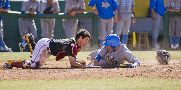 Garrett Stubbs collides with Ty Moore, with USC on the losing side for both the play and the game. (Twitter/@UCLABaseball)