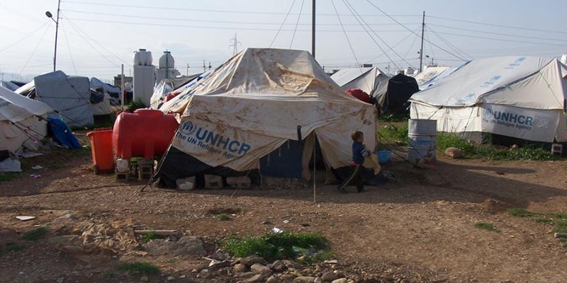 UNHCR tents at a refugee settlement. When applying for refugee status, an applicant can typically wait 15 months to 3 years undergoing a background check. (Wikimedia, Creative Commons)