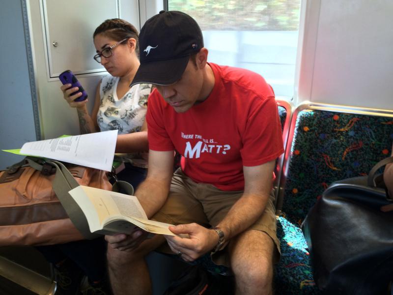 Eddie Vaughn, 36, reads a book while riding LA Metro's Gold Line. (J. Scott Cook/Annenberg Media)