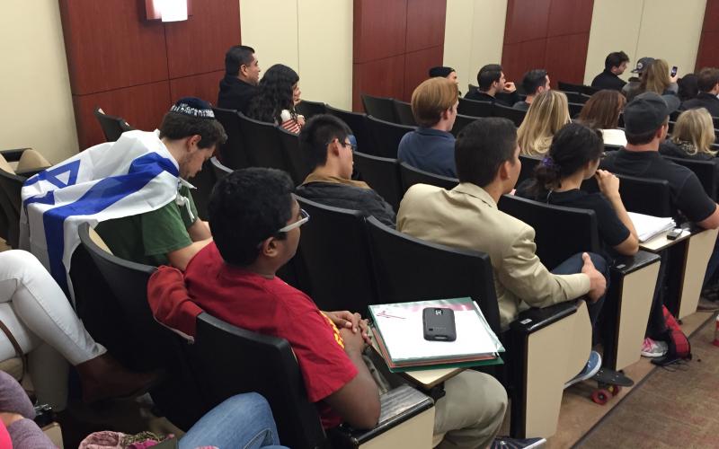 USC freshman biomedical engineering major Prajwal Bharadwaj (red shirt) listens to radio personality Ben Shapiro speak to the USC College Republicans about anti-Israel bias in the U.S. on Nov. 18, 2015. (Stephanie Haney/Annenberg Media)