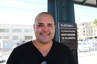 Angeleno Joey Sannella poses for a photo before hopping on the Metro Gold Line in Los Angeles. (Whitney Ashton / Annenberg Media) 