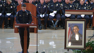 Fellow Downey Police Officer Drew Lofquist delivers a eulogy at Officer Ricky Galvez's funeral on Mon., Nov. 30, 2015. 