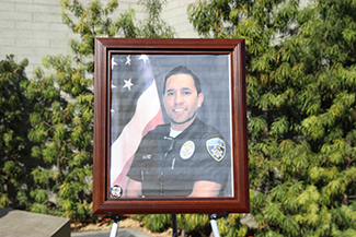 A memorial for Officer Ricardo Galvez was created in front of Downey Police headquarters on Thursday, Nov. 19, 2015. (Whitney Ashton/Annenberg Media)