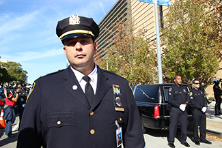 New York Police Department Lt. Christopher Popovic poses for a photo displaying his badge, draped with the badge number of fellow Officer Ricardo Galvez. (Whitney Ashton/Annenberg Media)