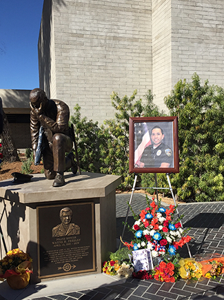 A memorial for Officer Ricardo Galvez was created in front of Downey Police headquarters on Thursday, Nov. 19, 2015. (Whitney Ashton/Annenberg Media) 
