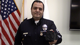 Los Angeles police Sgt. Dan Gomez, of the LAPD Tactical Technology Section, demonstrates the use of a body camera on Wed., Nov. 25, 2015. (Whitney Ashton/Annenberg Media)