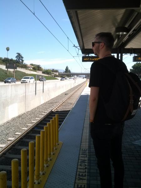 Claus, 25, waiting for the metro at the Lake Ave. stop in Pasadena.