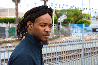 Robert Williams stands on the platform waiting at the Florence Street Station on the Los Angeles Metro Blue Line. (Daniel Tran/ Annenberg Media)