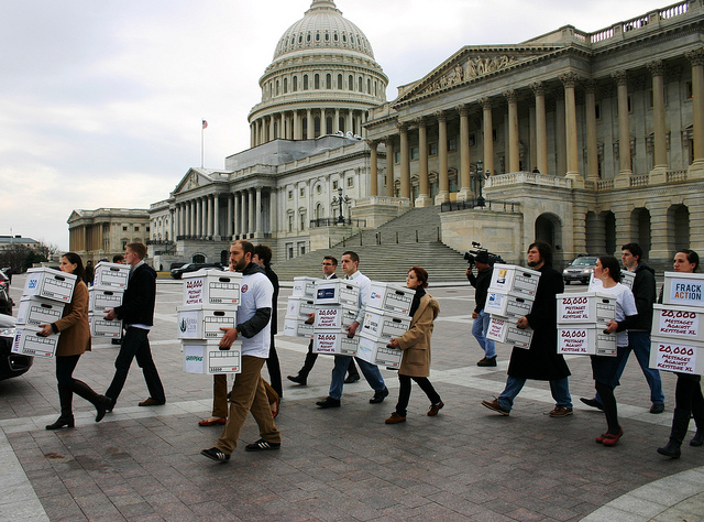 Environmentalists from 30 different organizations deliver more than 800,000 messages to Senators Reid McConnell on February 14, 2012, urging them to block attempts to resurrect the Keystone XL tar sands pipeline (Photo by 350.org, obtained via Creative Commons license)..