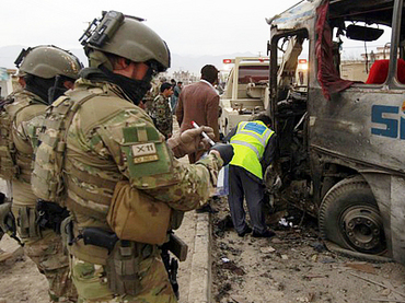 NATO forces inspects an Afghan army bus in Kabul earlier this year (rt.com)