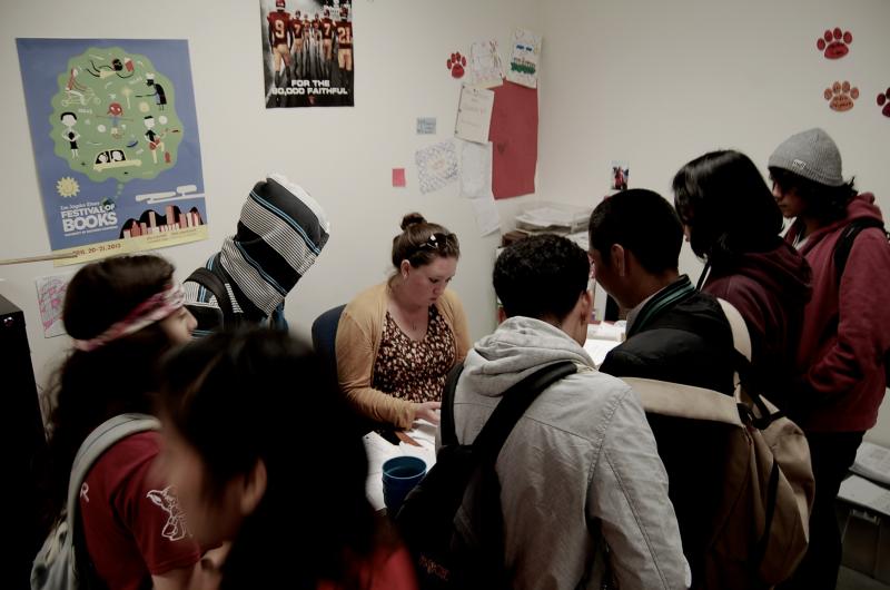 Lindsay holds her composure as a multitude of students surround her demanding her attention.