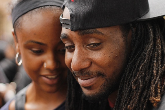 Nate Howard spends a quiet moment with a friend during the rally. (Aaron Liu/ Neon Tommy)