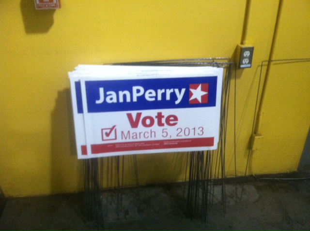 Stack of Perry signs against the wall. (Michael Juliani / Neon Tommy)