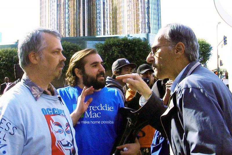 Domenic Pepe, right, argues with an Occupy L.A. demonstrator after security guards denied him entry into the Bank of New York Mellon building due to the presence of protesters (photo by Danny Lee).