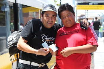 A father and son show off their tap cards. (Catherine Green/Neon Tommy)