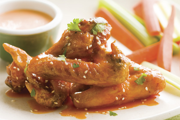 These Honey-Sriracha Glazed Hot Wings will kick your party up a few notches. (Lesley Balla/KCET Food) These Honey-Sriracha Glazed Hot Wings will kick your party up a few notches. (Lesley Balla/KCET Food)