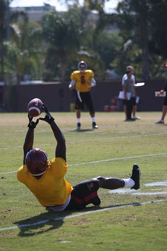 Marqise Lee, donning a no-contact pinny, snags a pass from Cody Kessler. (Kevin Tsukii/Neon Tommy)