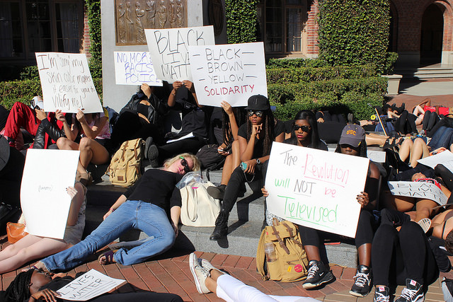 Students lie down in four and a half minutes of silence to honor Michael Brown, the black teenager who was fatally shot by a police officer in Ferguson, Missouri this past summer. (Rebecca Gibian/Neon Tommy)