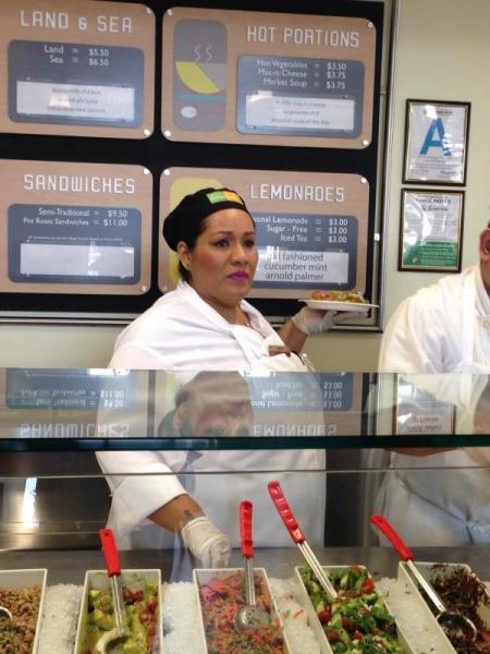 Abigail Lopez at work serving food at Lemonade. (Sarah Collins/Neon Tommy)