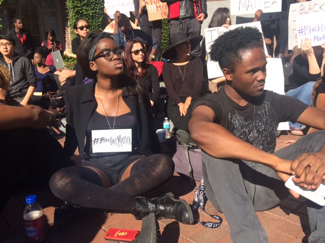 Joy Ofudu and David Elliott sit at the Ferguson response rally at USC on Tuesday morning. Both students have experienced being followed without probable cause, they said, and both worry about how to teach their kids about discrimination. (Michelle Toh/Neon Tommy)