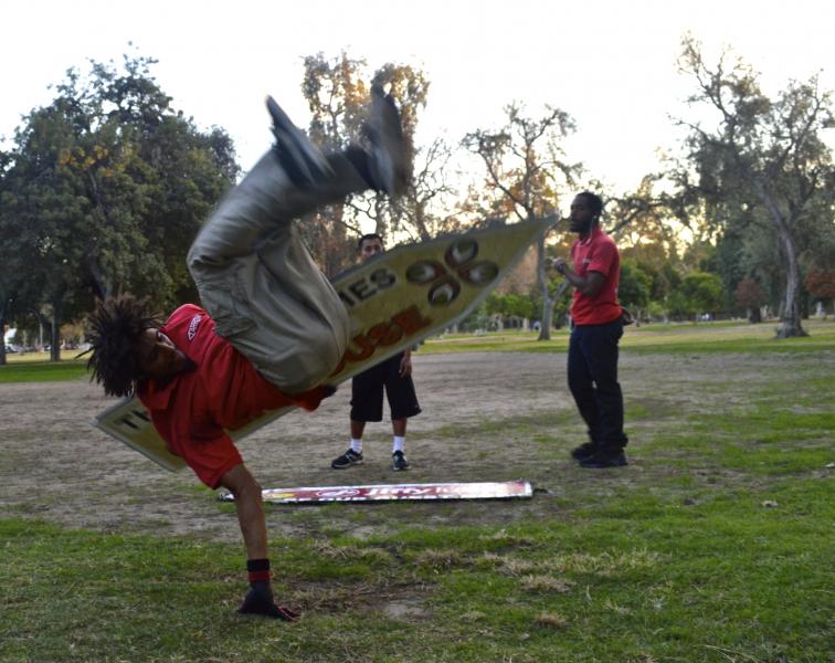 (Jeremy White doing a sign spinning flip/Brianna Sacks, Neon Tommy)