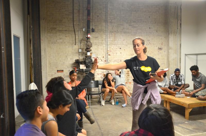 Stand-up comedian Susanna Spies high-fives a student during class (Olivia Niland/Neon Tommy)