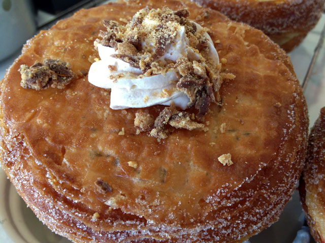 The "Peanut Butter Reese's Skronut" includes a peanut butter filling and is topped with Reese's candies (Kelli Shiroma / Neon Tommy). The "Peanut Butter Reese's Skronut" includes a peanut butter filling and is topped with Reese's candies (Kelli Shiroma / Neon Tommy).
