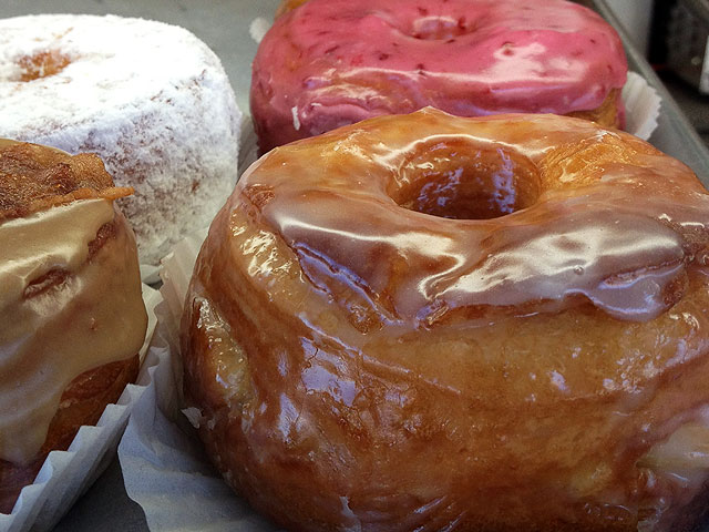 "Maple Bacon," "Nutella Nanna" and "Strawberry Cheesecake" are some of the most popular "Croissant Donut" flavors at California Donuts (Kelli Shiroma / Neon Tommy).