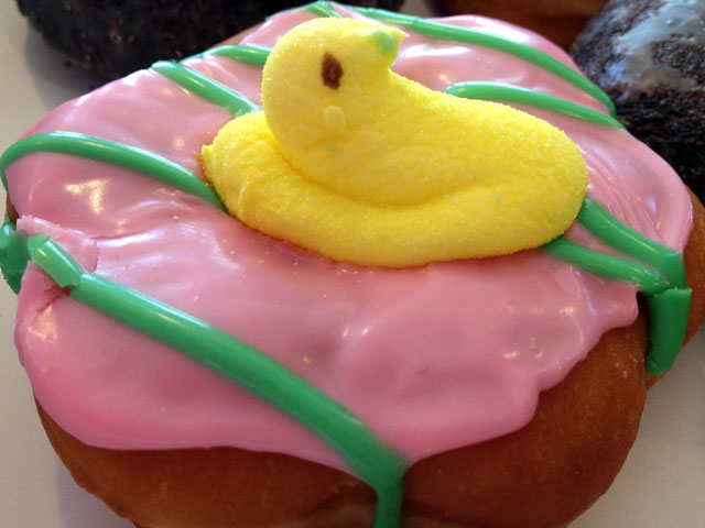 This Dunkin’ Donuts treat is covered with pastel pink icing and topped off with a yellow PEEPS marshmallow chick (Kelli Shiroma / Neon Tommy). This Dunkin’ Donuts treat is covered with pastel pink icing and topped off with a yellow PEEPS marshmallow chick (Kelli Shiroma / Neon Tommy).