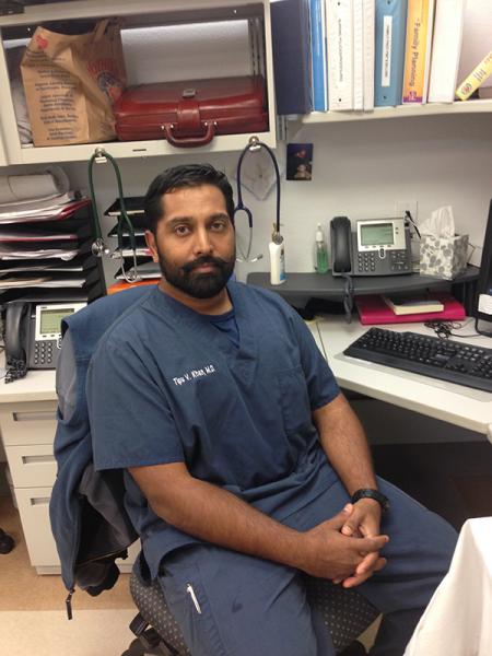 Tipu Khan, lead obstetrics provider at Umma Clinic, sitting at his desk.