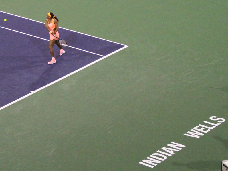 Under the lights on center court, Williams blazes a backhand return. (Bryce Christian)