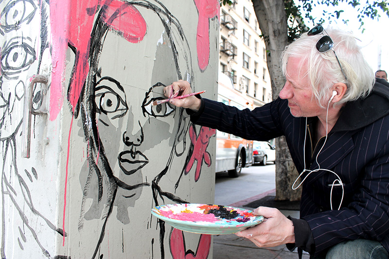 Local gallery artist Emmeric Konrad working on a utility box mural at Sixth and Spring in late March (Chrystal Li/Neon Tommy)