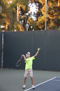 Asher serving a ball (Scarlett Zhiqi Chen/Neon Tommy) Asher serving a ball (Scarlett Zhiqi Chen/Neon Tommy)