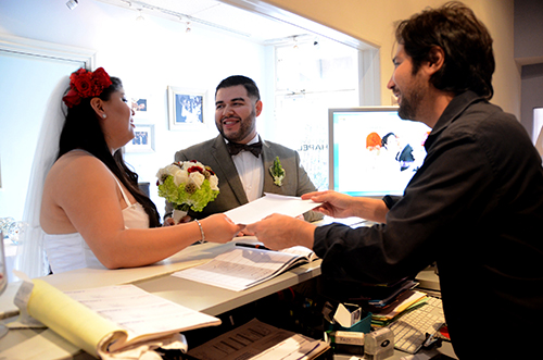 Daniel Franco leads a couple through their oath for their marriage license. (Photo by Hillary Jackson/Neon Tommy.) Daniel Franco leads a couple through their oath for their marriage license. (Photo by Hillary Jackson/Neon Tommy.)
