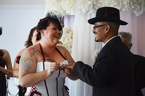 It's all laughs as Michelle Carper gives Eduardo Reyes his wedding band. (Photo by Hillary Jackson/Neon Tommy.) It's all laughs as Michelle Carper gives Eduardo Reyes his wedding band. (Photo by Hillary Jackson/Neon Tommy.)