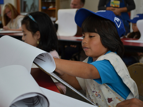Zane, 8 year-old, student visiting Inner-City Arts loves to draw as much as he can so he is taking lessons from art teacher and co-founder of Inner City Arts, Bob Bates, in the art classroom of the Inner-City Arts building located on Skid Row in Los Angeles, California, on Friday, January 25th, 2013. Zane, 8 year-old, student visiting Inner-City Arts loves to draw as much as he can so he is taking lessons from art teacher and co-founder of Inner City Arts, Bob Bates, in the art classroom of the Inner-City Arts building located on Skid Row in Los Angeles, California, on Friday, January 25th, 2013.