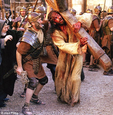 Christ (Jim Caviezel) carrying the cross to Calvary (Newmarket Films). Christ (Jim Caviezel) carrying the cross to Calvary (Newmarket Films).