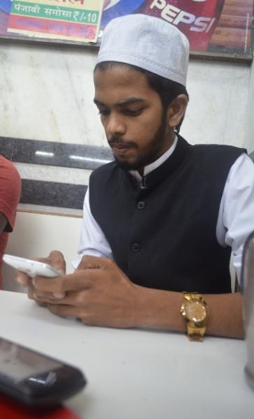 Akeel Shaikh contacts group members using the Whatsup app (Graham Clark)