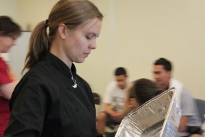 Sara Train wraps up dinnerware during one of her healthy cooking classes. (Kay Chinn)