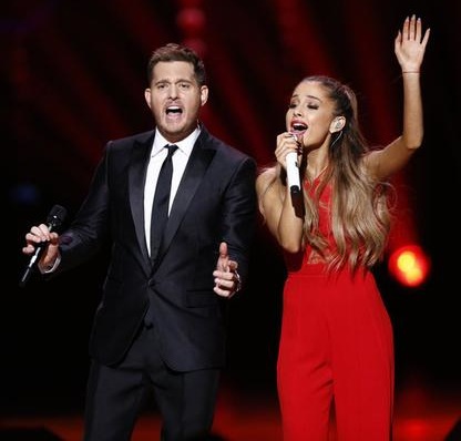 Michael Buble and Ariana Grande rock out Christmas-style (Twitter/@HeadlinePlanet). Michael Buble and Ariana Grande rock out Christmas-style (Twitter/@HeadlinePlanet).